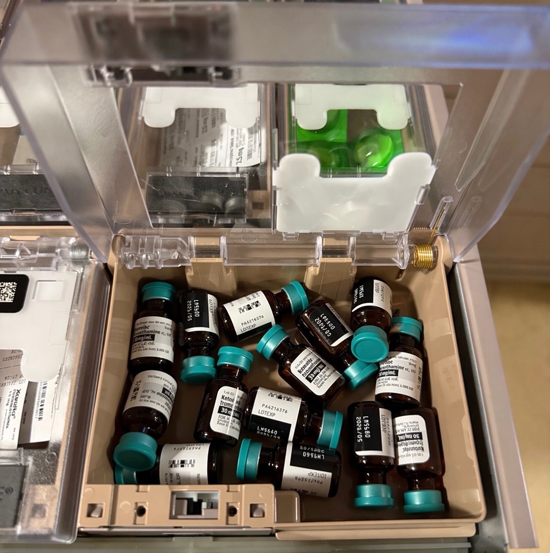 Loose medication vials in a Pyxis pocket requiring manual counting